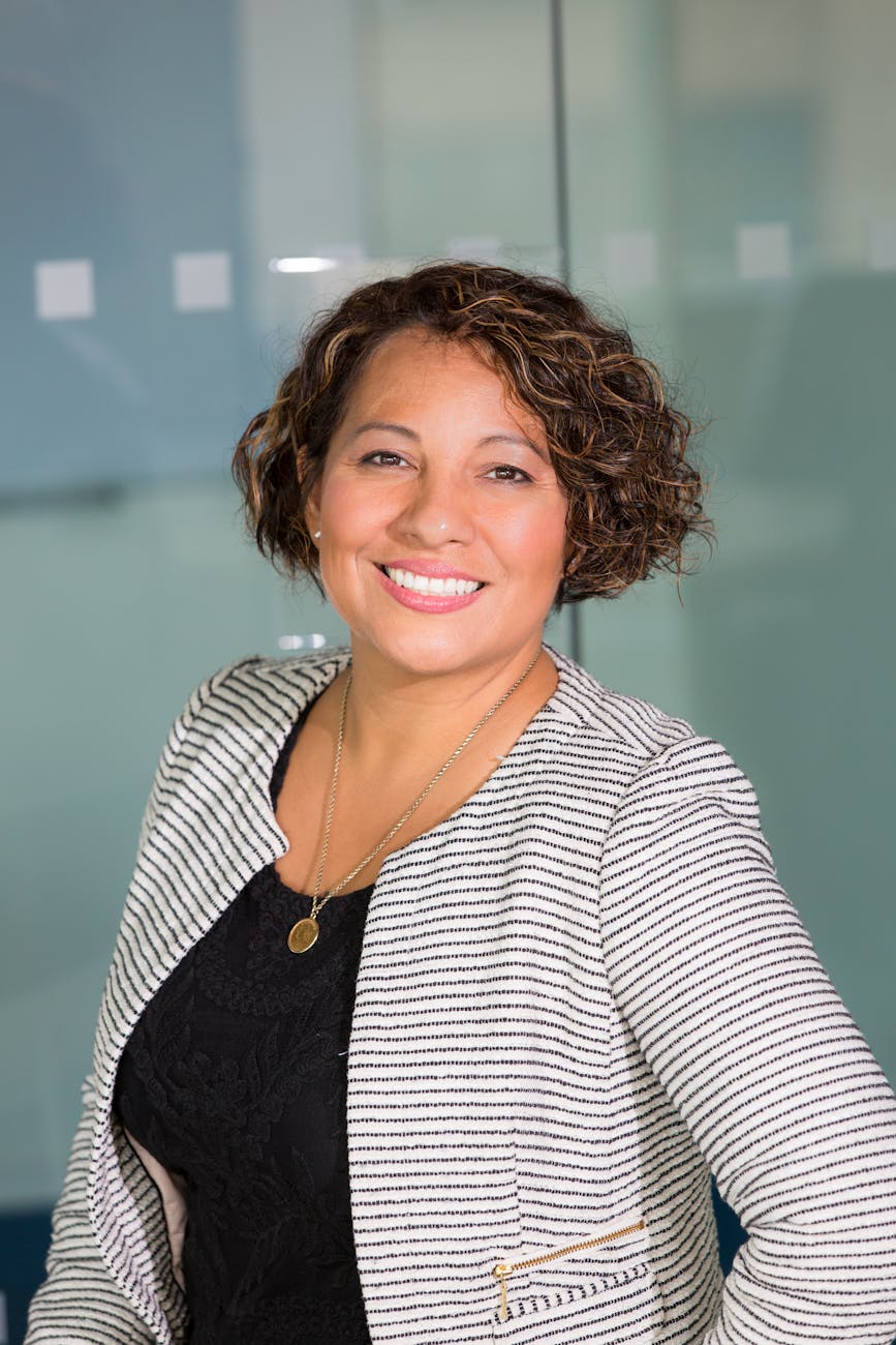 Portrait of a smiling professional woman in a modern office environment.
